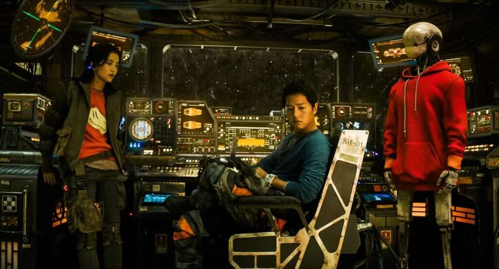 Capitã Jang, Kim Tae Ho e Bubs de costas para o painel de sua espaçonave